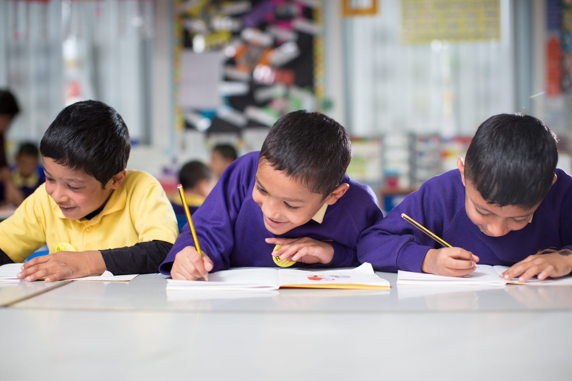 3 pupils writing Burnley Brow Community School