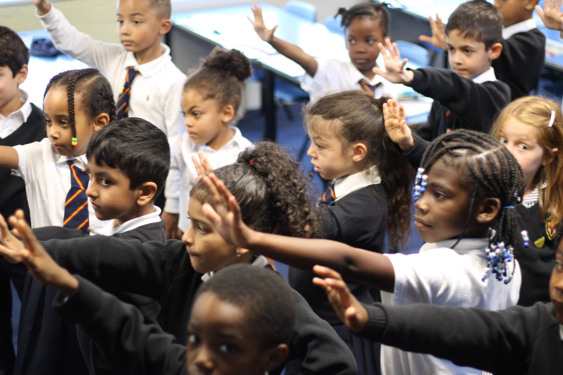 Smiling pupils with books St George's CE Primary